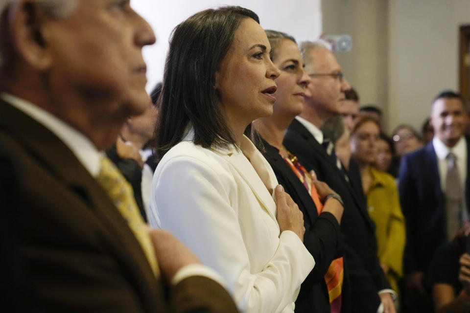 Maria Corina Machado joins int he singing of the Venezuelan national anthem during a ceremony with the Opposition Primary Commission to recognize her electoral win in the opposition-organized primary election to choose a presidential candidate in Caracas, Venezuela, Thursday, Oct. 26, 2023. (AP Photo/Ariana Cubillos)