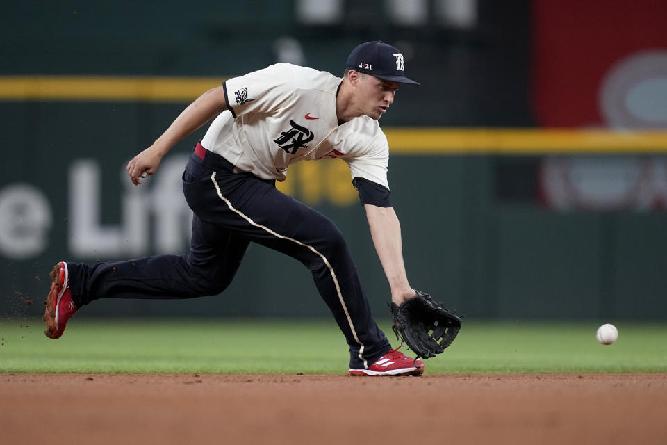 Texas Rangers shortstop Corey Seager reaches down to field a double-play ground ball by Minnesota Twins' Royce Lewis in the first inning of a baseball game Saturday, Sept. 2, 2023, in Arlington, Texas. Jorge Polanco was out at second on the play. (AP Photo/Tony Gutierrez)