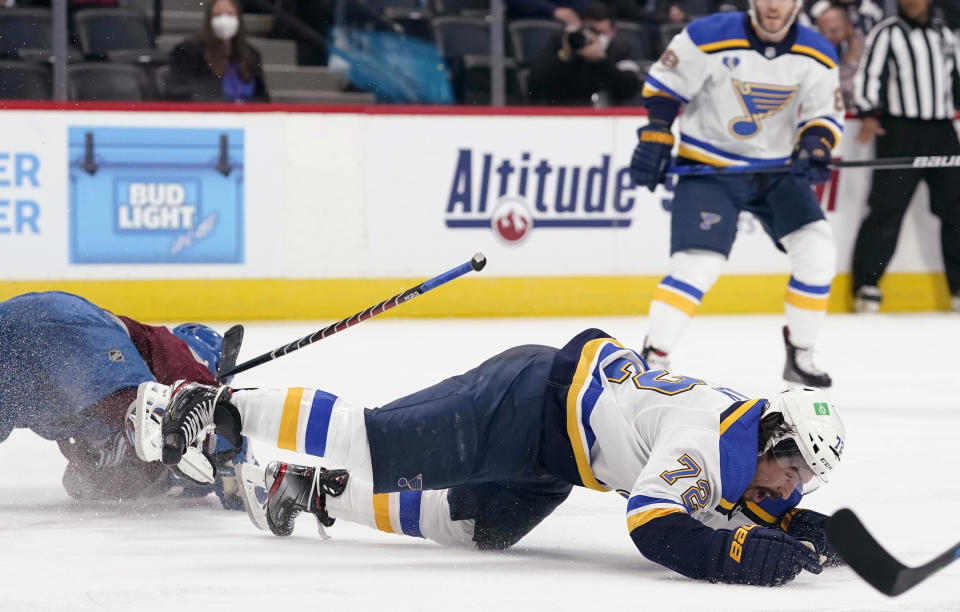 St. Louis Blues defenseman Justin Faulk, right, falls to the ice after he was hit by Colorado Avalanche center Nazem Kadri during the third period of Game 2 of an NHL hockey Stanley Cup first-round playoff series Wednesday, May 19, 2021, in Denver. Kadri was removed from the game for the hit. Colorado won 6-3. (AP Photo/David Zalubowski)