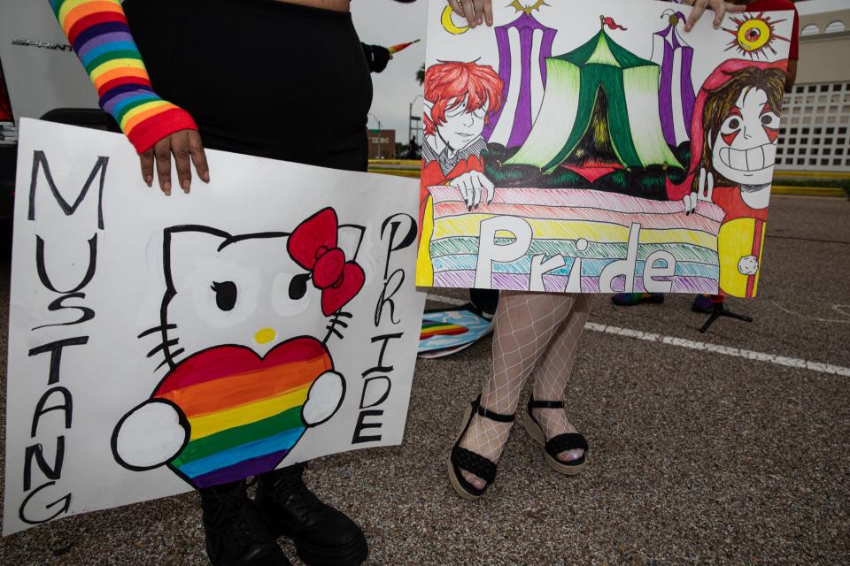 Beetle Molina and Ana Newton hold handmade signs for the Pride Parade and Block Party on Saturday, Oct. 7, 2023, in Corpus Christi, Texas.