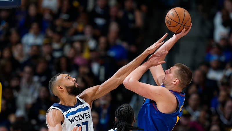 Minnesota Timberwolves center Rudy Gobert, left, goes up to block a shot by Denver Nuggets center Nikola Jokic, right, as Timberwolves center Naz Reid (11) looks on during a second-round playoff series Saturday, May 4, 2024, in Denver.