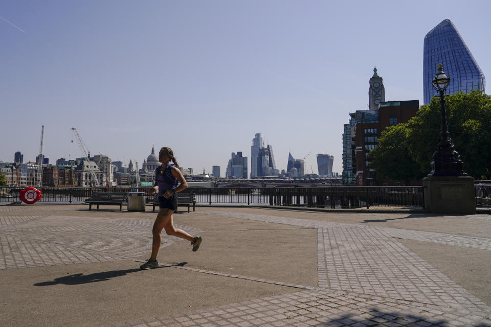 CAPTION CORRECTS TO WOMAN A woman runs on the south bank of river Thames, in London, Monday, July 18, 2022. Britain’s first-ever extreme heat warning is in effect for large parts of England as hot, dry weather that has scorched mainland Europe for the past week moves north, disrupting travel, health care and schools. (AP Photo/Alberto Pezzali)