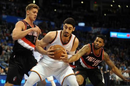 Apr 13, 2015; Oklahoma City, OK, USA; Oklahoma City Thunder center Enes Kanter (34) drives to the basket against Portland Trail Blazers center Meyers Leonard (11) and Portland Trail Blazers forward Alonzo Gee (33) during the fourth quarter at Chesapeake Energy Arena. Mark D. Smith-USA TODAY Sports/Files