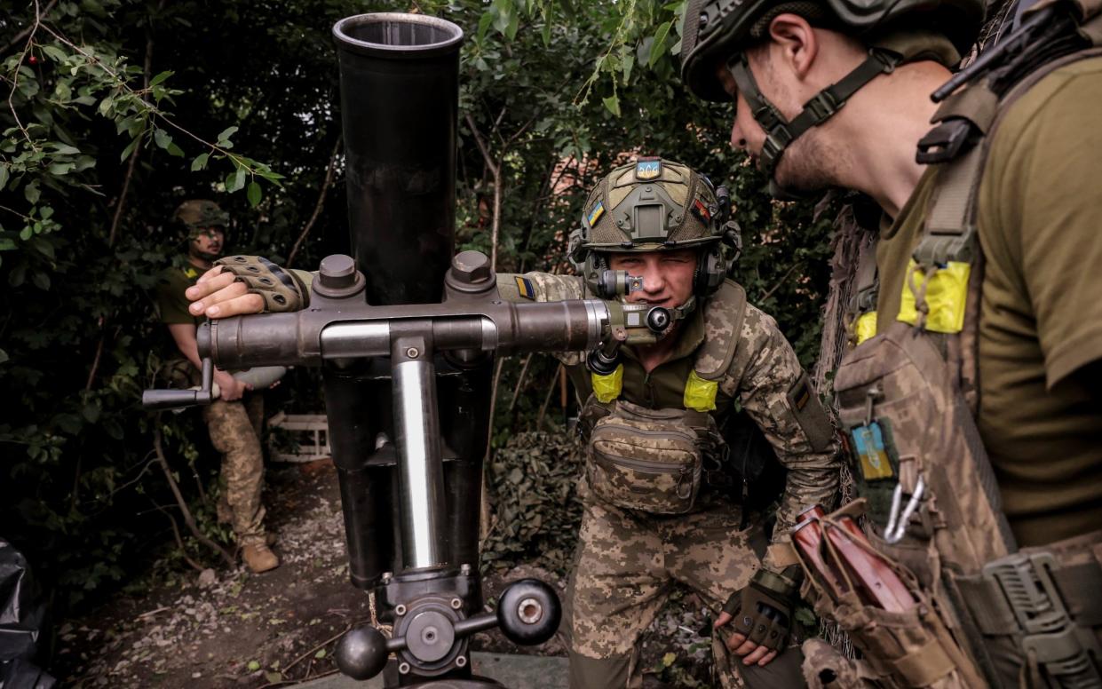 Members of Ukraine's 24th Mechanised brigade fire mortar towards Russian positions  on the front line at Chasiv Yar