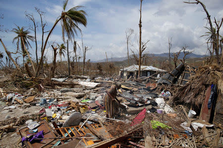 A woman walks on debris in an area devastated by Hurricane Matthew in Port-a-Piment, Haiti, October 9, 2016. REUTERS/Andres Martinez Casares