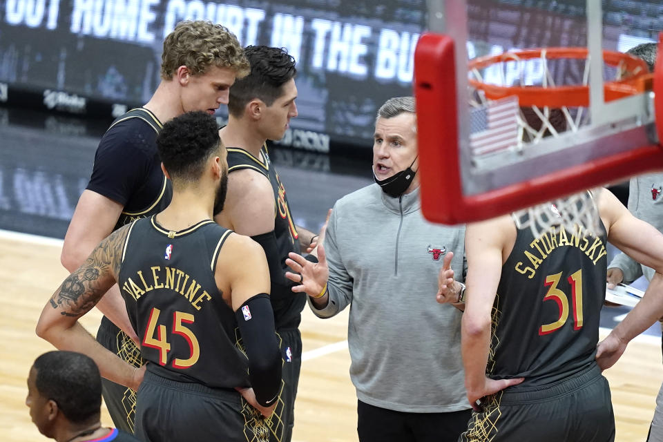 Chicago Bulls head coach Billy Donovan, second from right, talks to his players during a timeout in the second half of an NBA basketball game against the Charlotte Hornets, Thursday, April 22, 2021, in Chicago. (AP Photo/Charles Rex Arbogast)