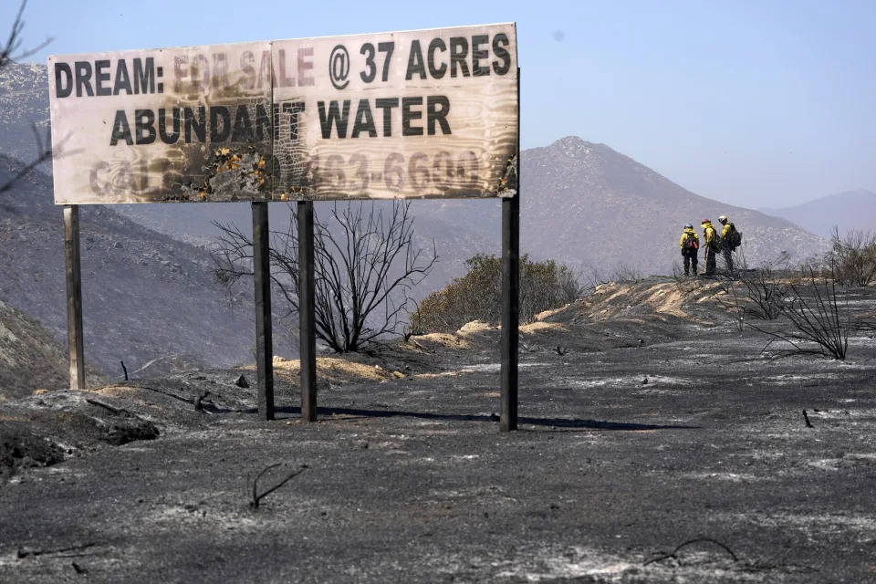 FILE - Fire crews work a wildfire on Sept. 1, 2022, near Dulzura, Calif. (AP Photo/Gregory Bull, file)