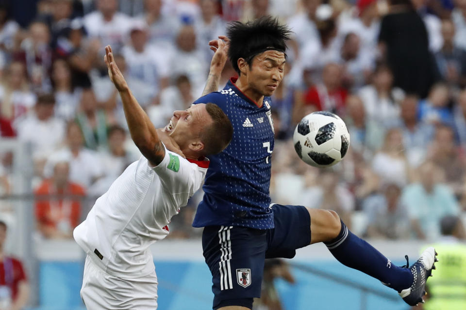 <p>Gaku Shibasaki hits the face of Jacek Goralski as they jump to head the ball </p>