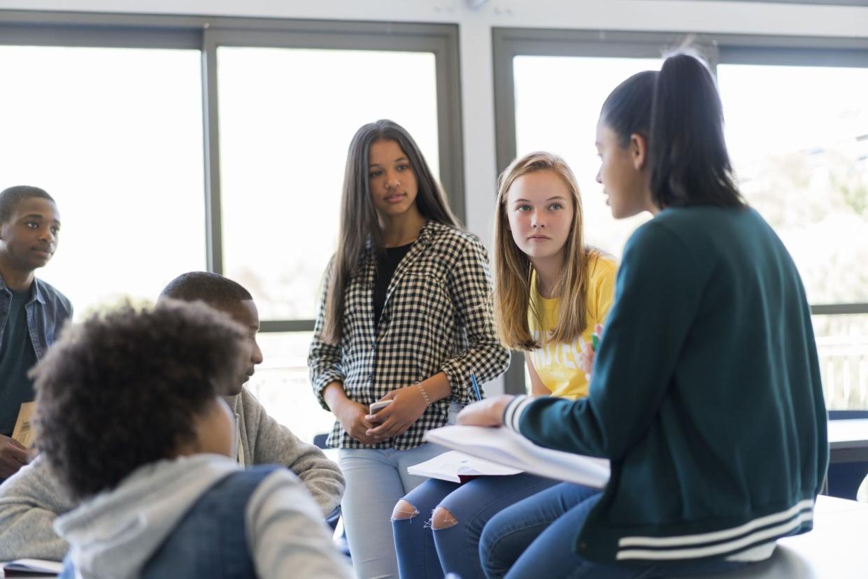 high school students discussing in classroom