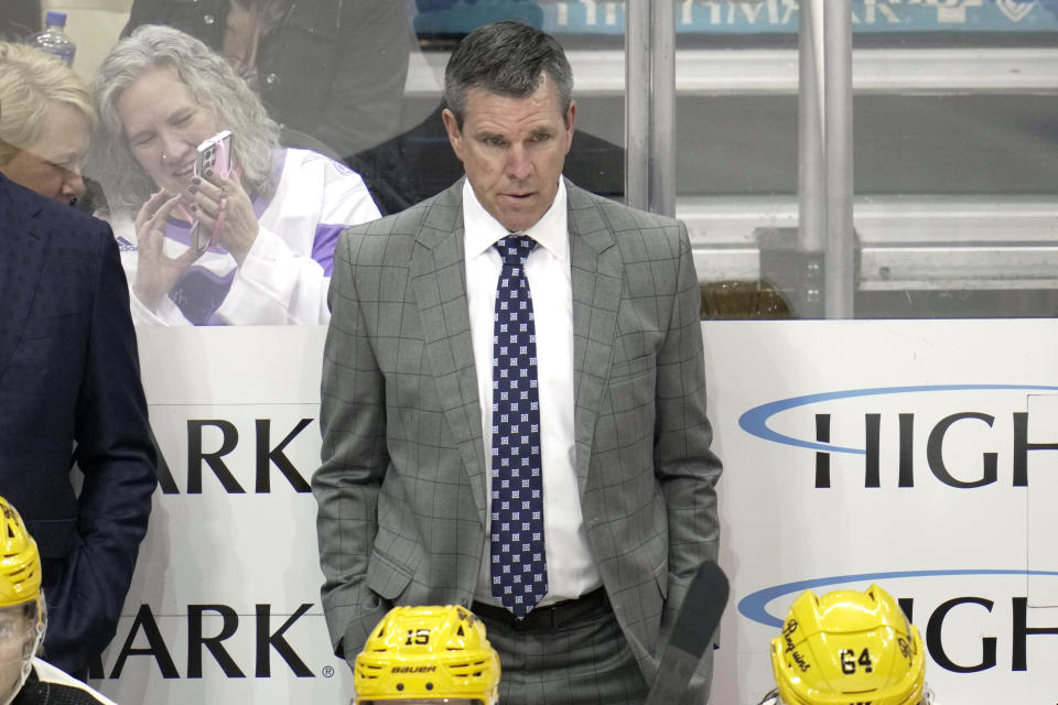 Pittsburgh Penguins head coach Mike Sullivan stands behind his bench during the third period of an NHL hockey game against the Philadelphia Flyers in Pittsburgh, Saturday, March 11, 2023. The Penguins won 5-1. (AP Photo/Gene J. Puskar)