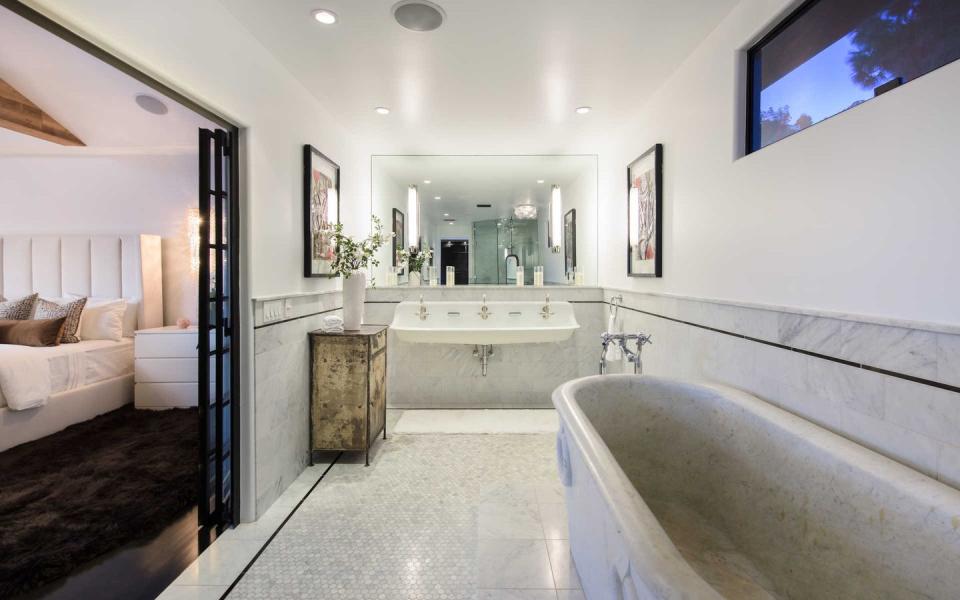 <p>Just off the master bedroom is a bathroom nearly entirely swathed in marble-which dates to the 19th century. </p>