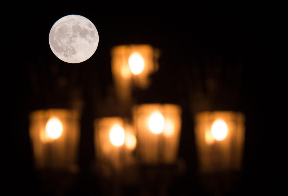 The "supermoon" is seen behind a street lamp in Dresden, Germany.