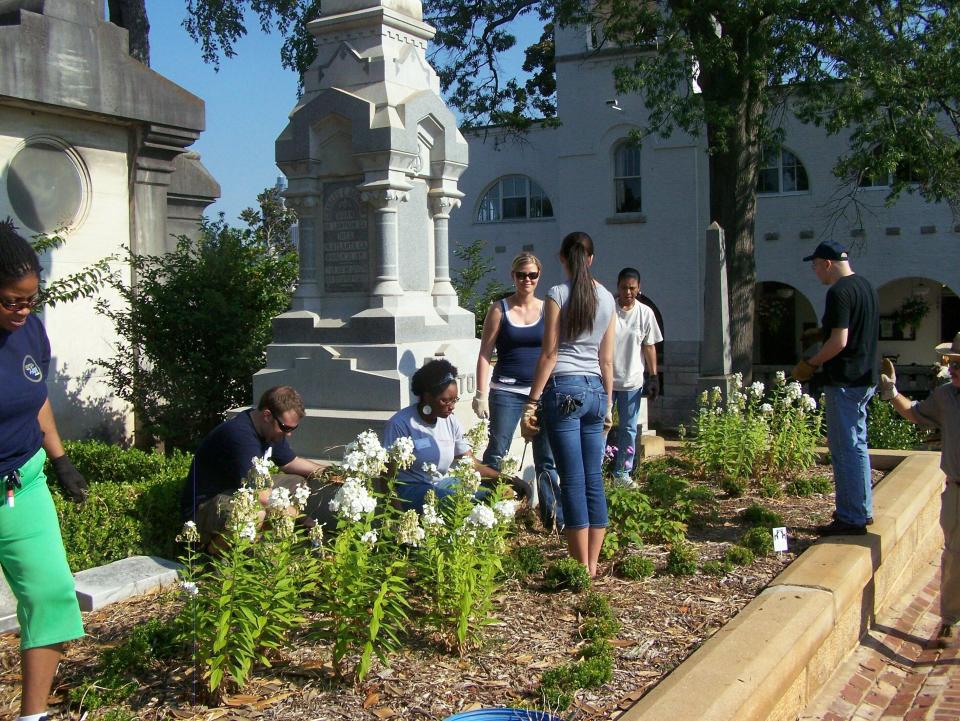 This undated photo, provided by Sara Henderson, shows a group of volunteers gardening Oakland Cemetery in Atlanta, Ga. Some cemeteries, like Oakland, rely on volunteers to landscape the grounds. (Sara Henderson via AP)