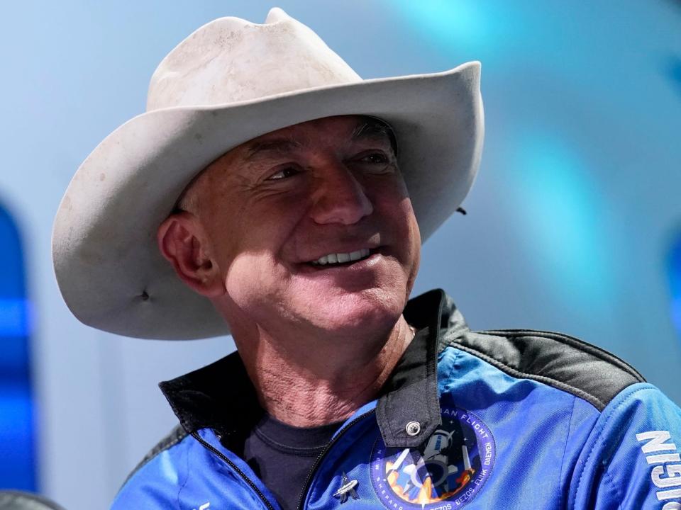 Jeff Bezos wearing cowboy hat and space suit at Blue Origin rocket launch