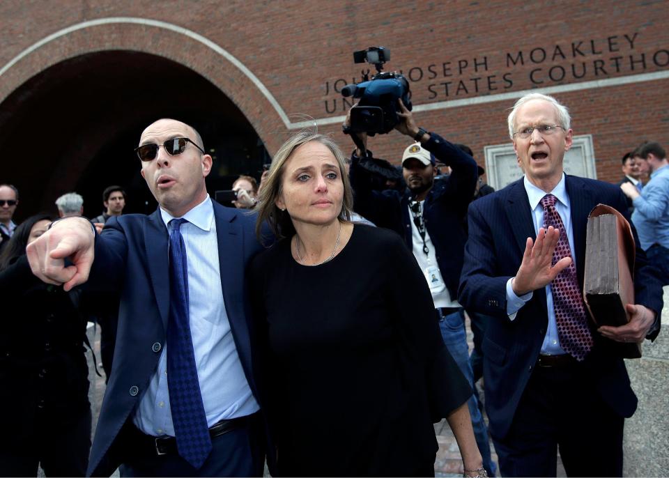 District Court Judge Shelley M. Richmond Joseph, center, departs federal court on April 25, 2019, in Boston after facing obstruction of justice charges for allegedly helping a man in the country illegally evade immigration officials.