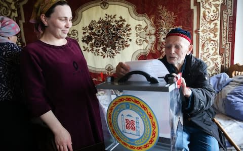 A man in Chechnya casts his ballot as part of home voting, which is often ripe for abuse far from observers' gaze - Credit: Yelena Afonina/TASS via Getty Images