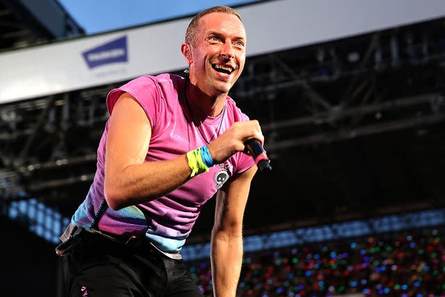 <p>Ole Jensen/Getty Images</p> Chris Martin of Coldplay performs live on stage at Parken Stadium in July 2023 in Copenhagen