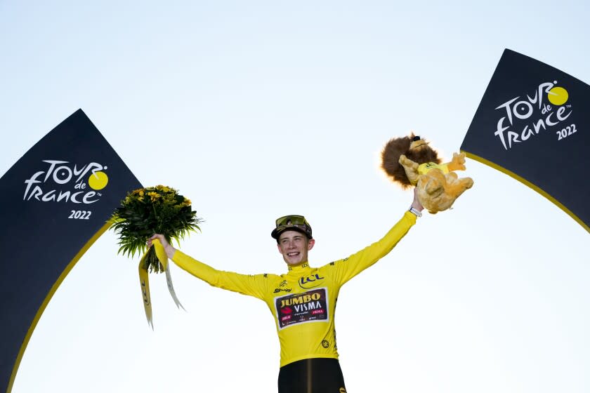 Tour de France winner Denmark's Jonas Vingegaard, wearing the overall leader's yellow jersey, celebrates on the podium after the twenty-first stage of the Tour de France cycling race over 116 kilometers (72 miles) with start in Paris la Defense Arena and finish on the Champs Elysees in Paris, France, Sunday, July 24, 2022. (AP Photo/Thibault Camus)
