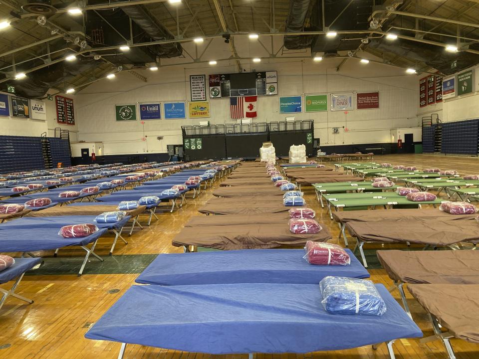 Bundles of bedding awaits unpacking on the floor of the Portland Expo, Friday, April 7, 2023, in Portland, Maine. The state is reopening a basketball arena for immigrants following the arrival of more than 800 asylums seekers since the beginning of the year. (AP Photo/David Sharp)