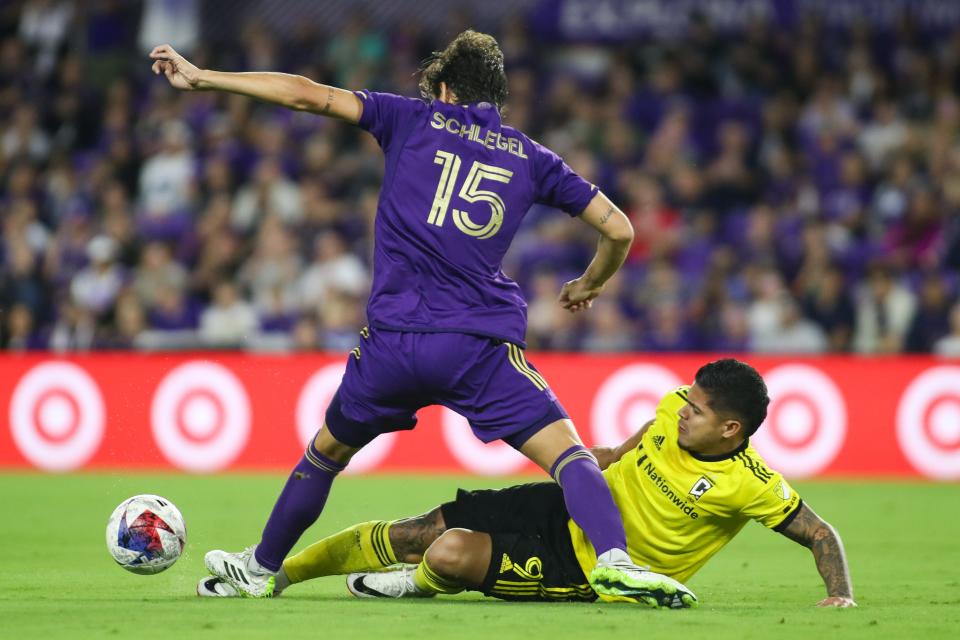 Nov 25, 2023; Orlando, Florida, USA; Columbus Crew forward Cucho Hernández (9) puts in a sliding tackle on Orlando City defender Rodrigo Schlegel (15) during the first half of a MLS Cup Eastern Conference Semifinal match at Exploria Stadium. Mandatory Credit: Morgan Tencza-USA TODAY Sports