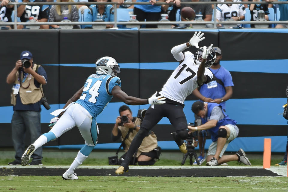 Carolina Panthers cornerback James Bradberry (24) defends while Jacksonville Jaguars wide receiver D.J. Chark (17) catches a pass during the second half of an NFL football game in Charlotte, N.C., Sunday, Oct. 6, 2019. (AP Photo/Mike McCarn)