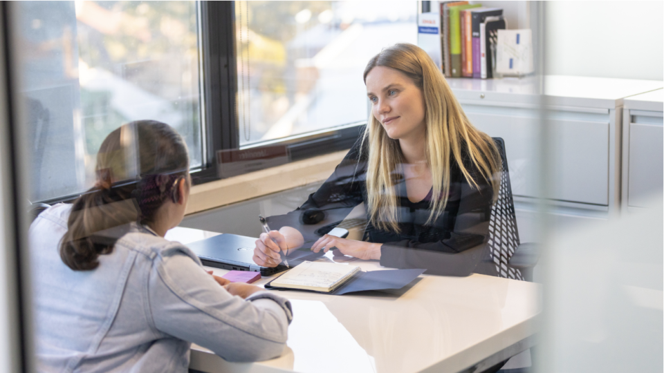 An image of a woman attending a job interview.