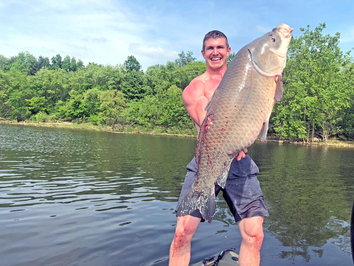 Josh Bowmar displays his Ohio record buffalo sucker, which he shot with a recurve bow. The fish weighed 43 pounds.