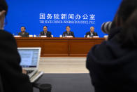 Officials attend a press conference at the State Council Information Office in Beijing, Saturday, Dec. 4, 2021. China's Communist Party took American democracy to task on Saturday, sharply criticizing a global democracy summit being hosted by President Joe Biden next week and extolling the virtues of its governing system. (AP Photo/Mark Schiefelbein)