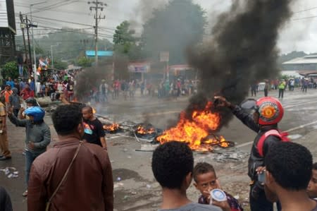 People burn tires during a protest at a road in Manokwari, West Papua, Indonesia