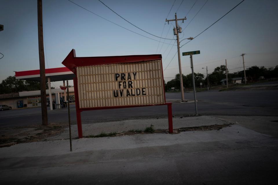 A drive-thru convenience store signage displays the words “Pray for Uvalde” on 29 May, days after a deadly school shooting took the lives of 19 children and two teachers, in Uvalde, Texas (AP)