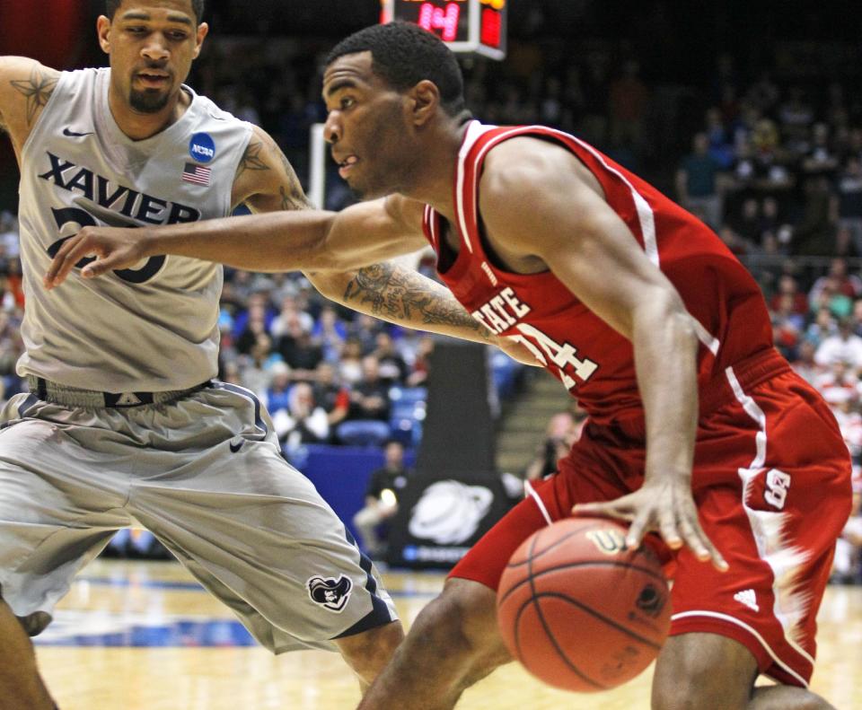 North Carolina State forward T.J. Warren (24) drives against Xavier forward Justin Martin during the first half of a first-round game of the NCAA college basketball tournament, Tuesday, March 18, 2014, in Dayton, Ohio. (AP Photo/Skip Peterson)