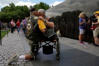 <p>In town for the Memorial Day weekend, Vietnam War veterans Jim Corrales (L) of Fontana, California and Mike Hodge of Seattle, Washington, comfort one another in front of the Vietnam Veterans Memorial in Washington, U.S., May 26, 2017. (Photo: Kevin Lamarque/Reuters) </p>