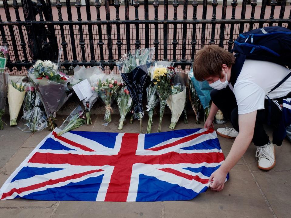 People gather outside Buckingham Palace, London, following the announcement of the death of the Duke of Edinburgh at the age of 99.