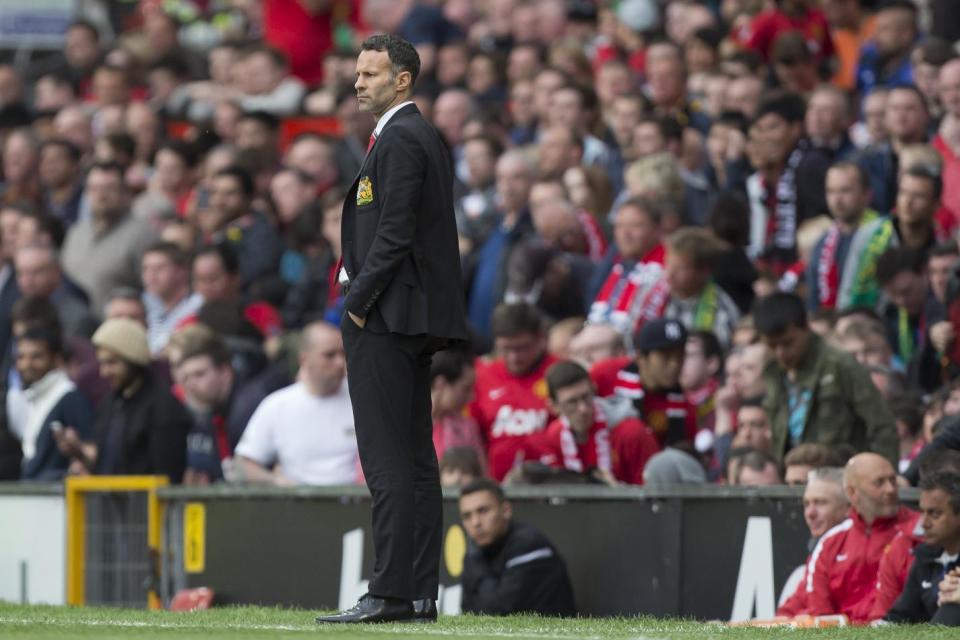 Manchester United's interim manager Ryan Giggs watches his team's 4-0 win against Norwich City in their English Premier League soccer match at Old Trafford Stadium, Manchester, England, Saturday April 26, 2014. (AP Photo/Jon Super)