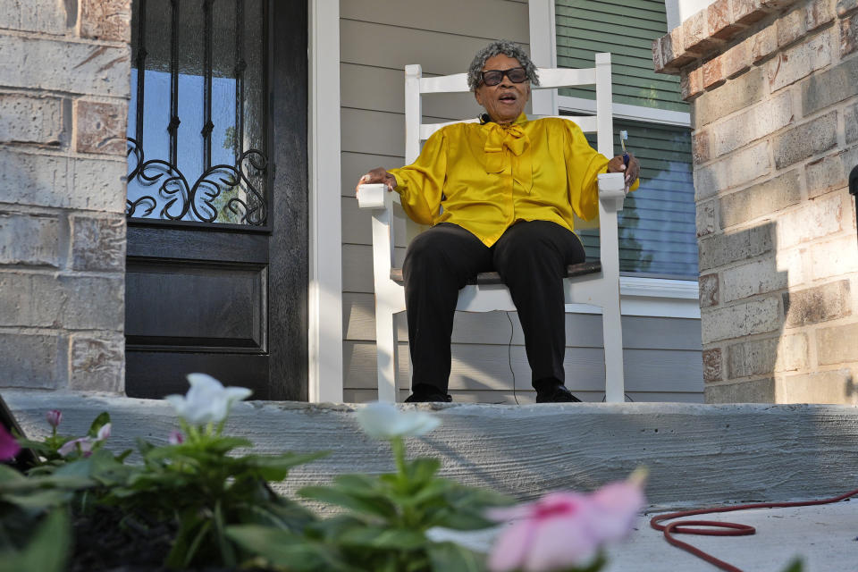 Opal Lee sits in a rocking chair while waiting to give interviews on the porch of her new home in Fort Worth, Texas, Friday, June 14, 2024. Habitat for Humanity built Lee the home on the same lot where as a child a white mob destroyed her family's home driving them away. (AP Photo/LM Otero)