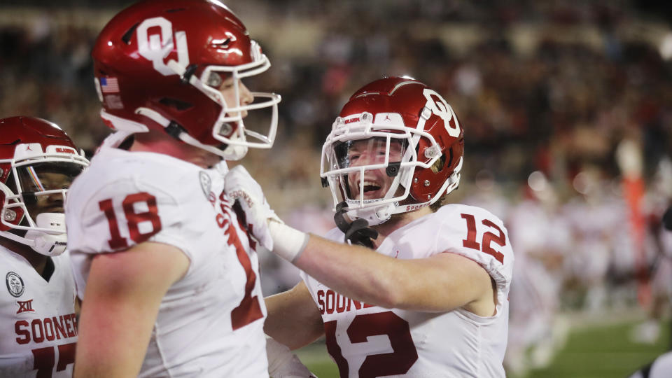 Oklahoma's Austin Stogner celebrates a touchdown catch with Drake Stoops during the first half of the team's NCAA college football game against Texas Tech on Saturday, Oct. 31, 2020, in Lubbock, Texas. (AP Photo/Mark Rogers)