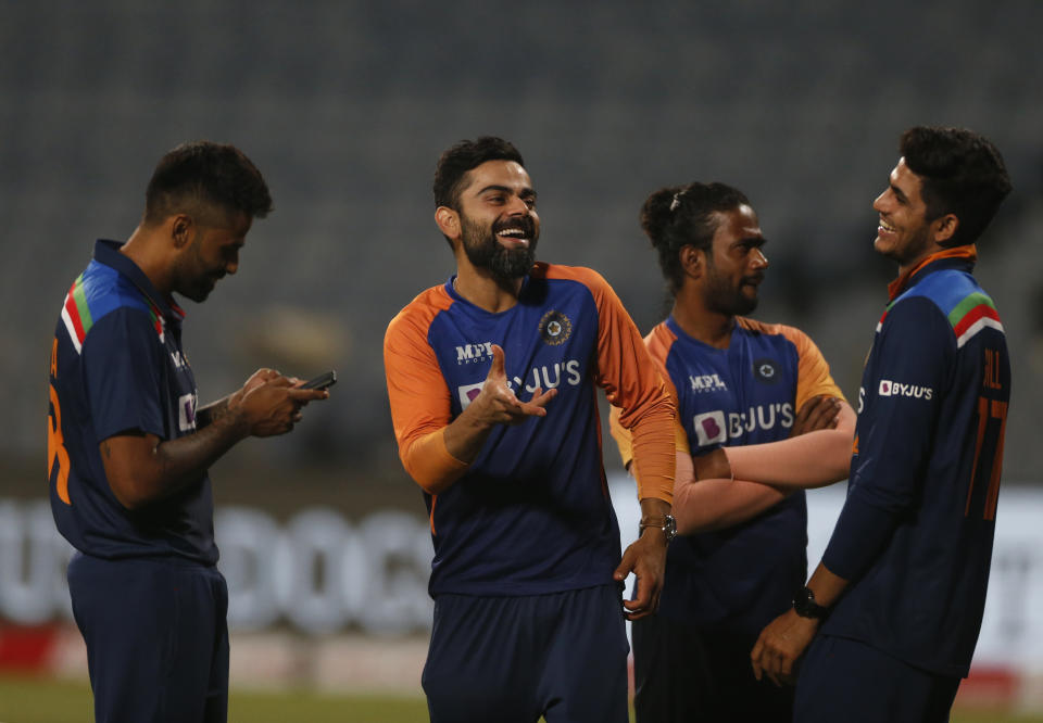 India's captain Virat Kohli, second left, shares a light moment with teammates after their win in the third One Day International cricket match between India and England at Maharashtra Cricket Association Stadium in Pune, India, Sunday, March 28, 2021. (AP Photo/Rafiq Maqbool)