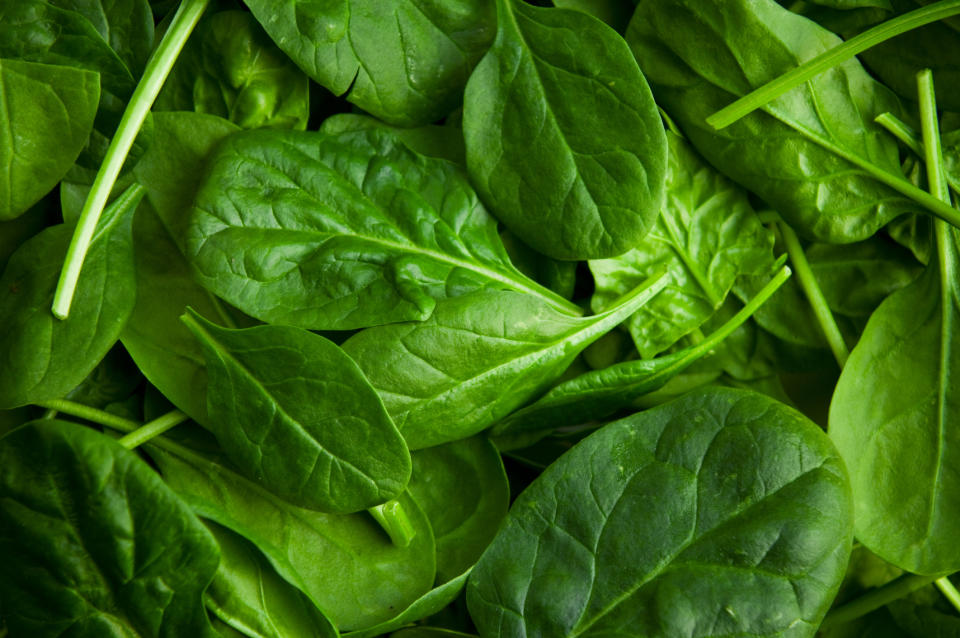 A close-up view of fresh spinach leaves overlapping each other