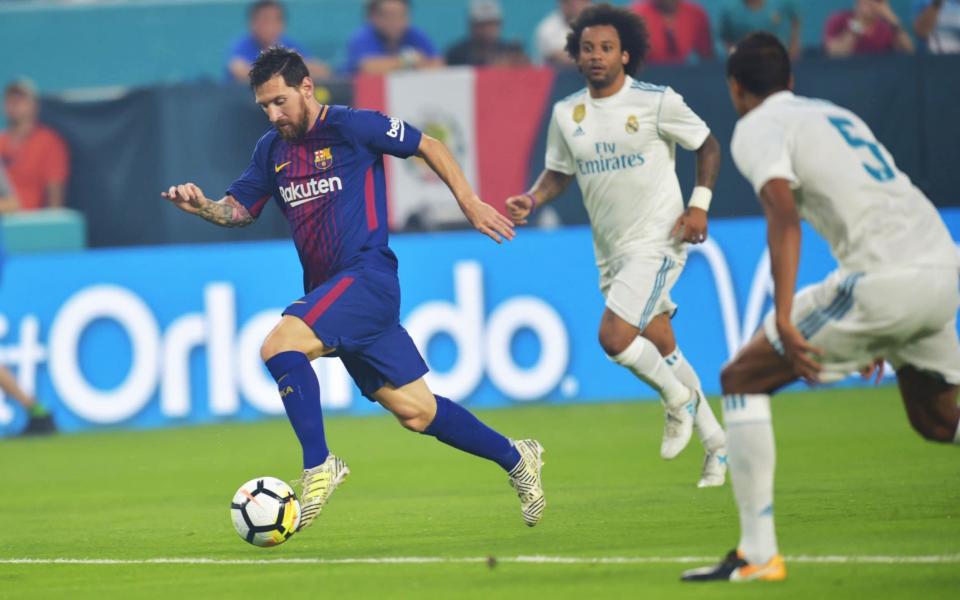 Lionel Messi of Barcelona vies for the ball with Real Madrid defense at the International Champions Cup friendly match at Hard Rock Stadium in Miami, Florida, on July 29, 2017 - Credit: AFP