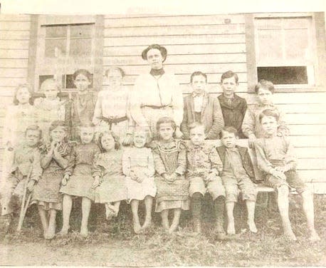 Students are pictured barefoot in 1910 at one of the one-room schools in Washington Township.