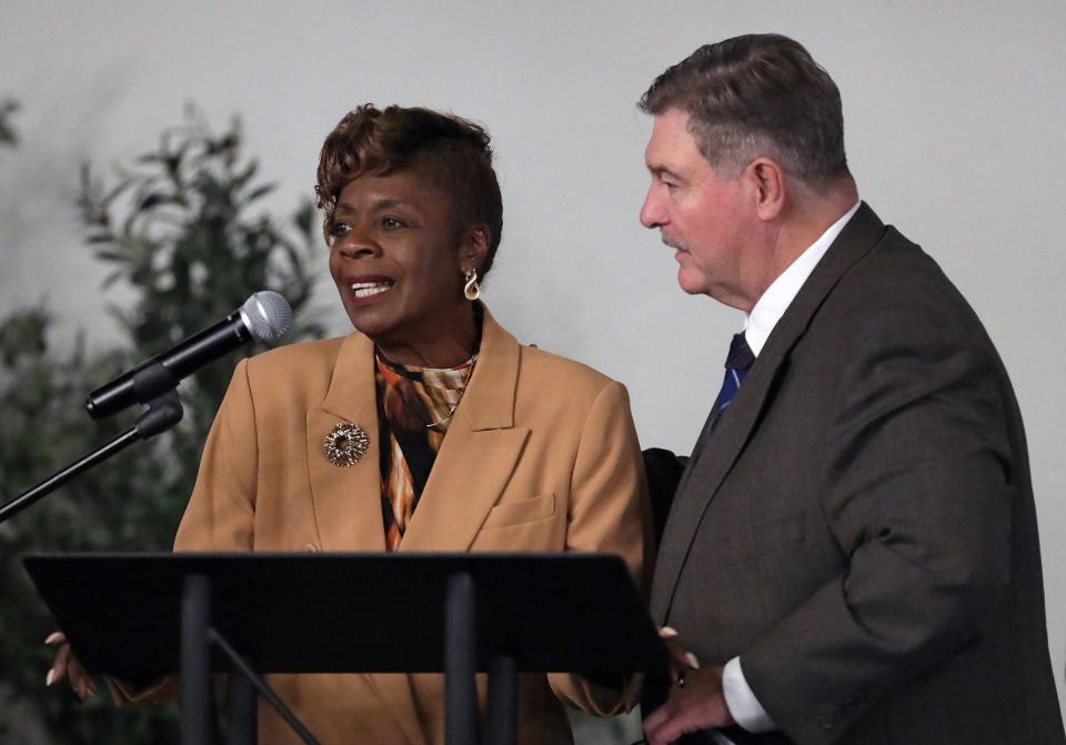 Evelyn Stokes, left, speaks on behalf of her brother, Gus Johnson, as Ron Linger looks on during the 2023 Akron Public Schools Athletics Hall of Fame induction ceremony Saturday at House Three Thirty in Akron.