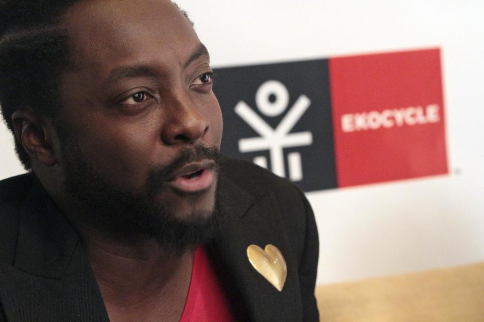 In this Wednesday, July 25 2012 photo, will.i.am speaks during an interview with the Associated Press in New York. In hopes of giving products made from recycled materials a little more cachet, musician will.i.am and The Coca-Cola Co. are partnering to make a line of clothes and gear called Ekocycle. The idea is to brand recycled products with a hipper image that resonates with young consumers. (AP Photo/Mary Altaffer)