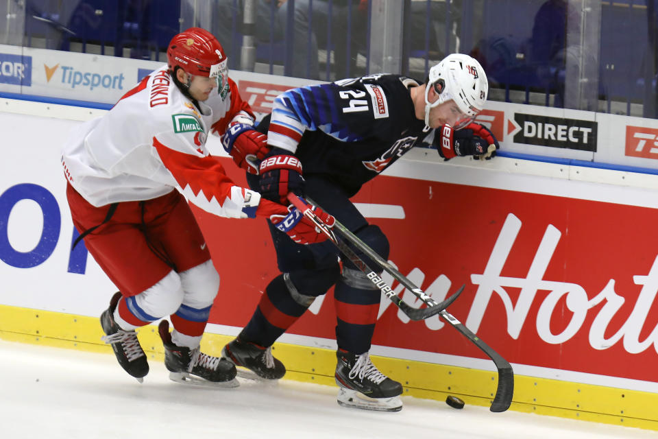 From left Kirill Marchenko of Russia and Mattias Samuelsson of the United States during the 2020 IIHF World Junior Ice Hockey Championships Group B match between USA and Russia in Ostrava, Czech Republic, on Sunday, December 29, 2019. (Petr Sznapka/CTK via AP)