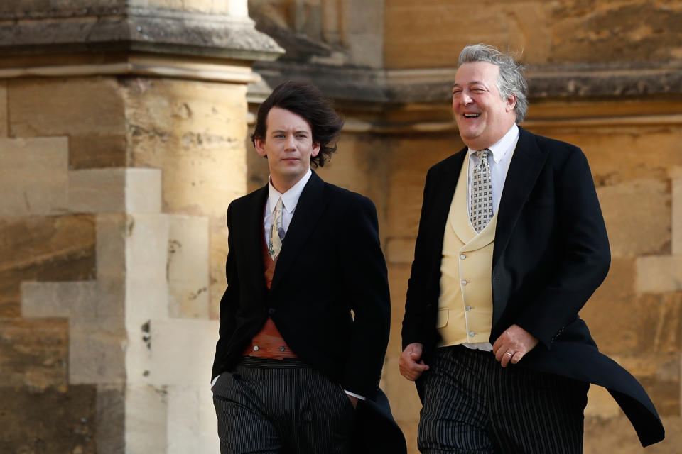 WINDSOR, ENGLAND - OCTOBER 12: British comedian and writer Stephen Fry (R) arrives with his husband comedian Elliott Spencer ahead of the wedding of Princess Eugenie of York and Mr. Jack Brooksbank at St. George's Chapel on October 12, 2018 in Windsor, England. (Photo by Adrian Dennis - WPA Pool/Getty Images)