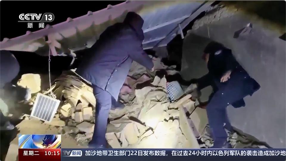 In this image taken from video footage run by China's CCTV, rescuers work near the rubble from an earthquake in Kizilsu Kirghiz Autonomous Prefecture, China’s western Xinjiang region Tuesday, Jan. 23, 2024. A strong earthquake struck China’s far western Xinjiang region early Tuesday, knocking out power and destroying homes, local authorities and state media reported. (CCTV via AP) ORG XMIT: TKMY801