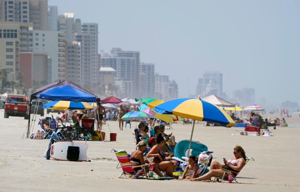 Beachgoers set up along the shore in Daytona Beach Shores over Memorial Day weekend in 2021. Big crowds are expected beachside this holiday weekend, according to the Daytona Beach Police Department.