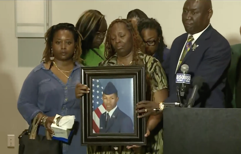 Mika Fortson, the mother of Senior Airman Roger Fortson, holds a photo of her son as civil rights attorney Ben Crump speaks to reporters on Thursday, May 9, 2024.
