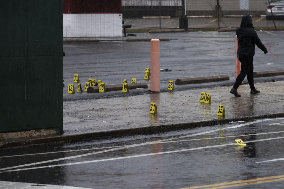 FILE - Evidence markers dot the ground following a shooting in Northeast Philadelphia on Wednesday, March 6, 2024. The last of four suspects in the shooting that wounded eight Philadelphia high school students at a bus stop earlier this month was captured Tuesday, March 19, in Virginia. (AP Photo/Joe Lamberti, File)