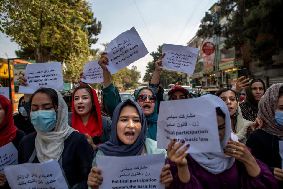 Afghan women hold placards during a demonstration demanding better rights for women in front of the former Ministry of Women Affairs in Kabul (AFP via Getty Images)