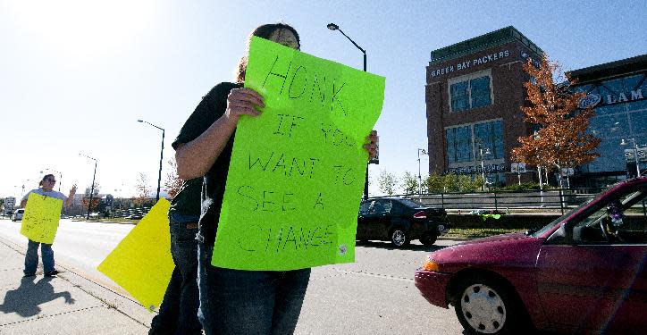 Alicia Schadrie holds a sign Tuesday, Sept. 25, 2012 on Lombardi Avenue in Green Bay, Wisc., in protest of a controversial call in the Packers 14-12 loss to the Seattle Seahawks, Monday night in Seattle. Just when it seemed that NFL coaches, players and fans couldn't get any angrier, along came a fiasco that trumped any of the complaints from the weekend. The Seahawks' victory featured one of the most bizarre finishes in recent memory, and was certain to reignite frustrations over the locked-out officials. (AP Photo/The Green Bay Press-Gazette, Lukas Keapproth ) NO SALES